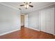 Spacious bedroom with a ceiling fan, hardwood floors, and ample closet space at 10091 Bannister St, Spring Hill, FL 34608