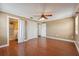 Spacious bedroom featuring a ceiling fan, hardwood floors, and ample closet space at 10091 Bannister St, Spring Hill, FL 34608