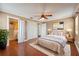Cozy bedroom with ceiling fan, hardwood floors, and ensuite bathroom at 10091 Bannister St, Spring Hill, FL 34608