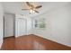 Bright bedroom featuring hardwood floors, a ceiling fan and a single window offering natural light at 10091 Bannister St, Spring Hill, FL 34608