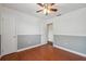 Bedroom with hardwood floors and two tone gray and white walls with white trim at 10091 Bannister St, Spring Hill, FL 34608