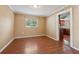 Bright dining room with hardwood floors and view into kitchen, ready for decor at 10091 Bannister St, Spring Hill, FL 34608