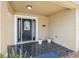 Inviting front porch with decorative tile flooring and space for potted plants at 10091 Bannister St, Spring Hill, FL 34608