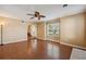 Bright living room with hardwood floors, ceiling fan, and arched doorway at 10091 Bannister St, Spring Hill, FL 34608