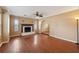 Spacious living room with hardwood floors, a fireplace, and ample natural light at 10091 Bannister St, Spring Hill, FL 34608