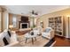 Cozy living room featuring a fireplace, ceiling fan, and a stylish bookshelf at 10091 Bannister St, Spring Hill, FL 34608