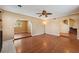 Open-concept living room with wood floors, archways, and staircase access at 10091 Bannister St, Spring Hill, FL 34608
