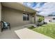 Back porch with neutral color stucco and green grass at 10115 Ringling St, New Port Richey, FL 34655