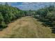 Scenic view of community center, framed by lush trees on a large grassy lawn under a blue sky at 10115 Ringling St, New Port Richey, FL 34655
