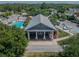 Community clubhouse with a serene pool area is surrounded by lush trees and well maintained landscaping at 10115 Ringling St, New Port Richey, FL 34655