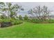 A tranquil community park featuring benches, manicured lawns, and mature trees at 10115 Ringling St, New Port Richey, FL 34655