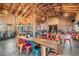 Spacious dining area with long wooden tables and colorful metal chairs for patrons at 10115 Ringling St, New Port Richey, FL 34655