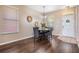 Bright dining area with a round table, gray chairs, wood flooring, and natural light from windows at 10115 Ringling St, New Port Richey, FL 34655