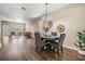 Well-lit dining area with a round table, gray chairs, wood flooring, and open access to the living room at 10115 Ringling St, New Port Richey, FL 34655