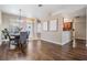 Open dining room with wood floors, stylish chandelier, and view of front door and kitchen at 10115 Ringling St, New Port Richey, FL 34655