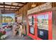 The entrance to the market has red framed doors, wooden facade and merchandise at 10115 Ringling St, New Port Richey, FL 34655