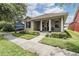 Charming front exterior showcasing manicured landscaping and a welcoming covered porch at 10115 Ringling St, New Port Richey, FL 34655