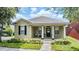 Charming home featuring a cozy front porch with stylish columns and a well-maintained lawn at 10115 Ringling St, New Port Richey, FL 34655