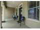 Covered front porch with seating and house number above front door at 10115 Ringling St, New Port Richey, FL 34655