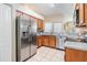 Kitchen boasts stainless steel appliances, granite countertops, tile backsplash, and ample storage at 10115 Ringling St, New Port Richey, FL 34655