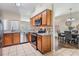 Open kitchen with stainless steel appliances, granite countertops, tile flooring, and dining area at 10115 Ringling St, New Port Richey, FL 34655