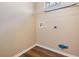 A laundry room area with wood look flooring and connections for a washer and dryer at 10115 Ringling St, New Port Richey, FL 34655