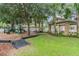 Community playground and picnic gazebo surrounded by shady trees, mulch, and grassy areas for play at 10115 Ringling St, New Port Richey, FL 34655