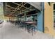 Outdoor seating beneath a black canopy complements the inviting exterior of a local establishment at 10115 Ringling St, New Port Richey, FL 34655