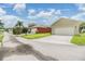 Residential street with homes, driveways, and lush green lawns under a bright sky at 10115 Ringling St, New Port Richey, FL 34655