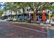 Charming street view of local eateries with brick-paved street and trees offering a delightful ambiance at 10115 Ringling St, New Port Richey, FL 34655