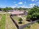 Aerial view of a fenced backyard with a patio, fire pit, and storage shed at 10124 Heathcliff St, Spring Hill, FL 34608