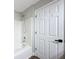 Bright bathroom featuring a shower over tub and a white door with black hardware at 10124 Heathcliff St, Spring Hill, FL 34608
