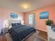 Cozy bedroom features a comfortable bed, blue bedding and artwork at 10124 Heathcliff St, Spring Hill, FL 34608