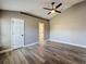 Spacious bedroom featuring hardwood floors, a ceiling fan, and an ensuite bathroom at 10124 Heathcliff St, Spring Hill, FL 34608