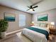 Stylishly decorated bedroom with hardwood floors, a fan, and contemporary decor at 10124 Heathcliff St, Spring Hill, FL 34608