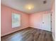 Bedroom features a window, wood-look flooring and neutral paint at 10124 Heathcliff St, Spring Hill, FL 34608