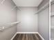 Spacious walk-in closet features wood-look flooring and wire shelving for optimal storage at 10124 Heathcliff St, Spring Hill, FL 34608