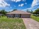 Charming single-story home featuring a two-car garage and landscaped front yard at 10124 Heathcliff St, Spring Hill, FL 34608