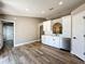 Modern kitchen featuring white cabinets, stainless steel appliances, and wood-look floors at 10124 Heathcliff St, Spring Hill, FL 34608