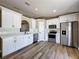 Bright kitchen features white cabinetry, stainless steel appliances and a stylish subway tile backsplash at 10124 Heathcliff St, Spring Hill, FL 34608