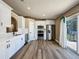 Bright kitchen features white cabinetry, stainless steel appliances and sliding doors to the patio at 10124 Heathcliff St, Spring Hill, FL 34608