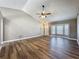 Bright living room featuring vaulted ceilings, wood-look floors, and natural light from bay window at 10124 Heathcliff St, Spring Hill, FL 34608
