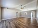 Open living room with vaulted ceilings, wood-look floors, and arched doorways at 10124 Heathcliff St, Spring Hill, FL 34608