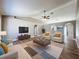 Bright staged living room with vaulted ceiling, wood-look floors, and comfortable seating at 10124 Heathcliff St, Spring Hill, FL 34608