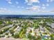 A high-angle, aerial showcases a dense residential community with many tree-covered yards and community amenities at 1071 Lexington Ct, Largo, FL 33771
