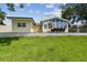 Large grassy backyard featuring a deck area perfect for entertaining or relaxing at 1071 Lexington Ct, Largo, FL 33771
