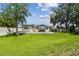 Expansive backyard featuring a deck, lush green lawn, and privacy fence perfect for outdoor entertaining at 1071 Lexington Ct, Largo, FL 33771