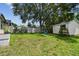 The backyard with swing set, storage shed, and well-maintained lawn, offers a relaxing space for outdoor enjoyment at 1071 Lexington Ct, Largo, FL 33771