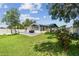 This backyard boasts a deck, lush lawn, swing set, and privacy fence, creating the perfect outdoor oasis at 1071 Lexington Ct, Largo, FL 33771
