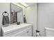 Modern bathroom featuring a white vanity, black hardware, framed mirror, and neutral tile at 1071 Lexington Ct, Largo, FL 33771